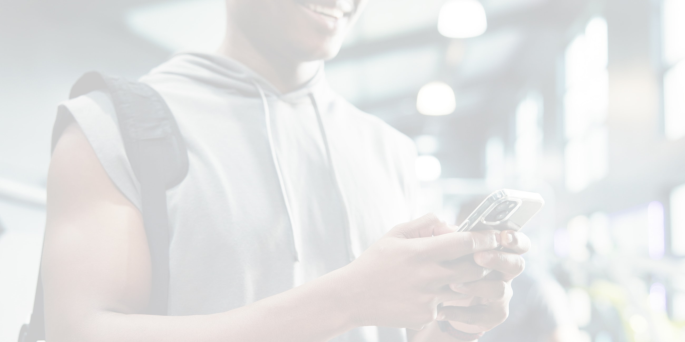 Person texting on phone in gym setting