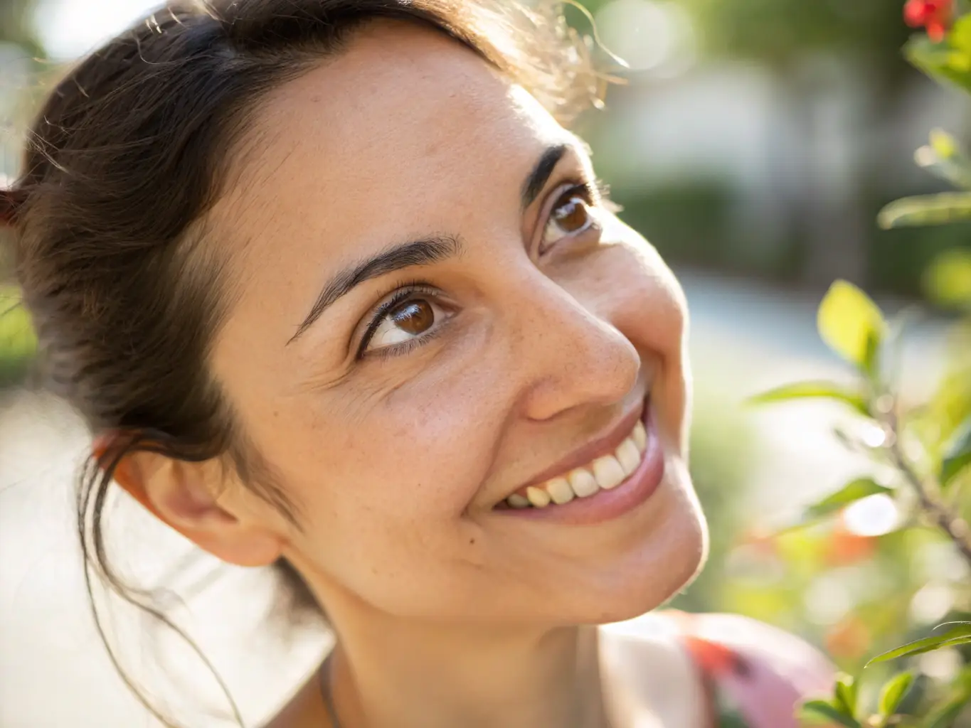 A close-up of a smiling middle-aged woman with glowing skin, representing youthful vitality.