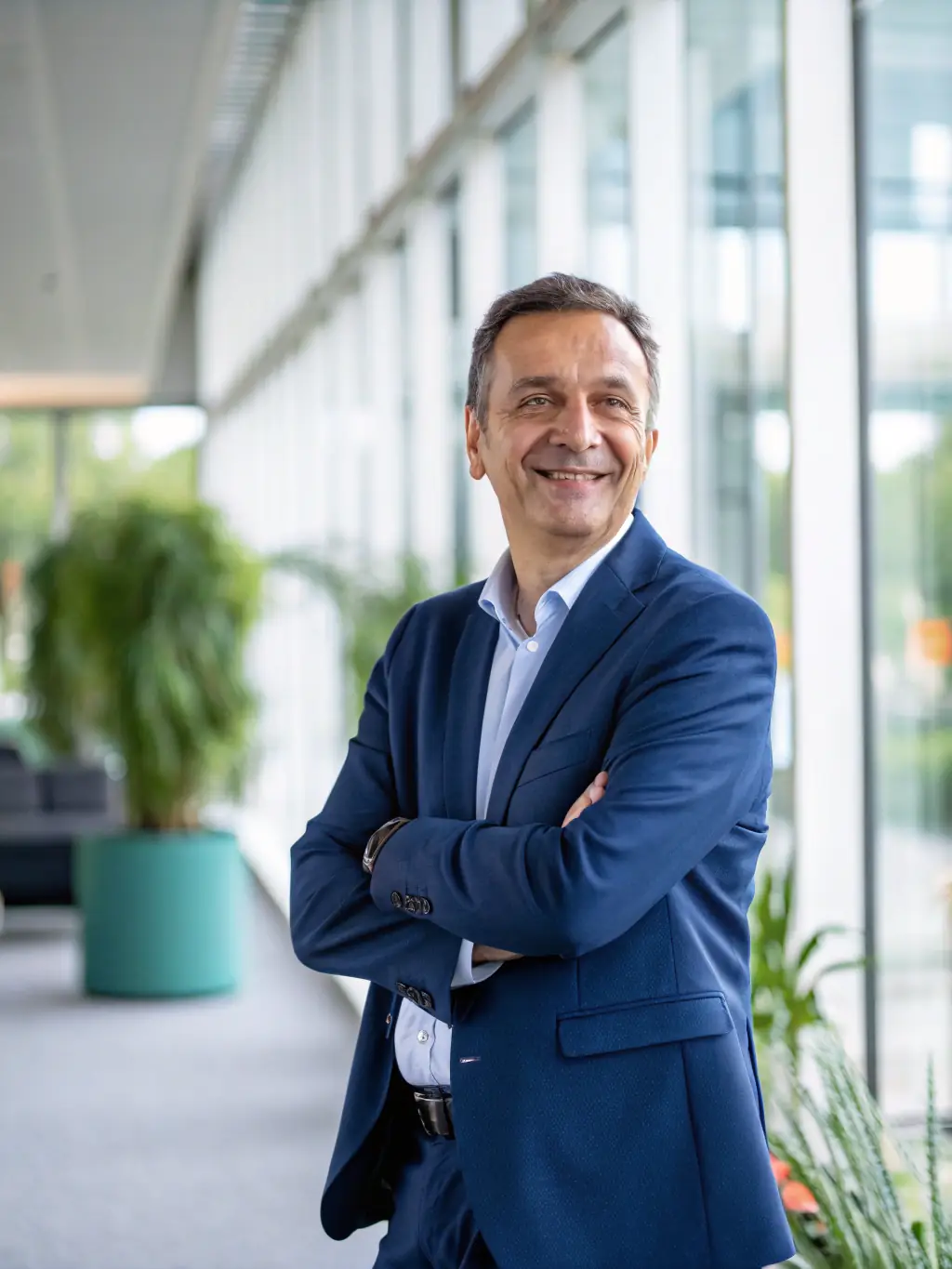 A confident man in his 40s, looking healthy and vibrant, representing the target demographic for the Elite Men’s Optimization program. The background is a professional office setting.